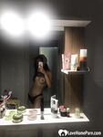 Hot schoolgirl reveals her tits in the mirror - Photo #1