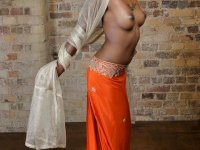 Indian MILF displays her firm breasts and hairless pussy during solo action - Photo #1