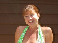 Older redhead amateur Dee Delmar bangs one guy then another behind her house - Photo #1