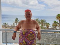 Obese nan with spiky red hair unveils her tits on balcony before posing naked - Photo #1