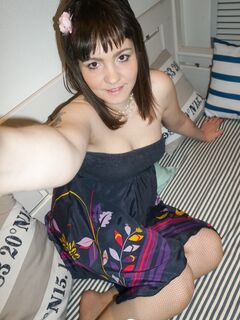 Brunette teen teasing in stockings in the bedroom