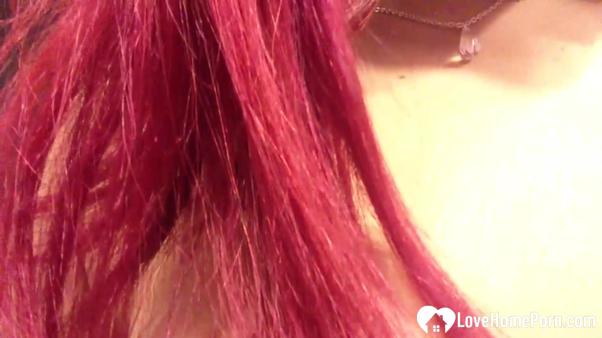 Pink-haired babysitter has fun with a toy